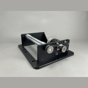 Compact cable tensioner or winch mounted on a black metal base, with a silver shaft and two silver rollers.